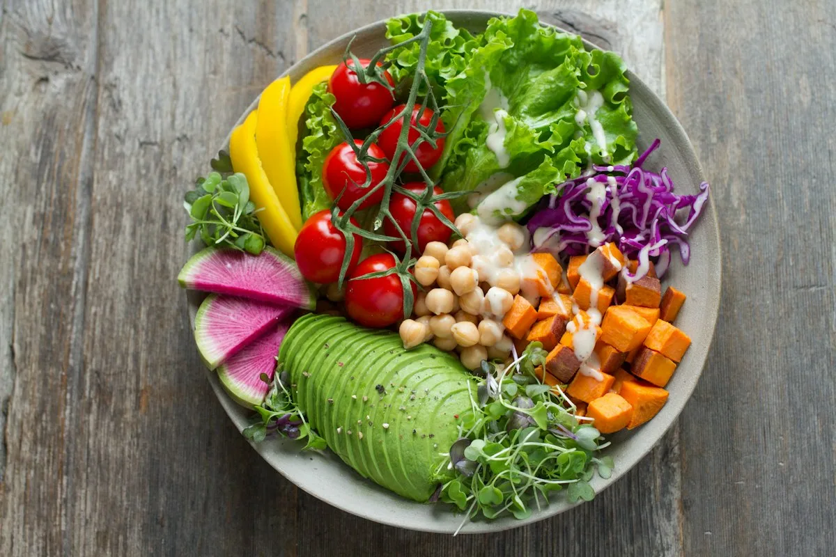 Colorful Greek salad bowl filled with crisp cucumbers, ripe avocado cubes, hearty chickpeas, kalamata olives, and fresh feta cheese