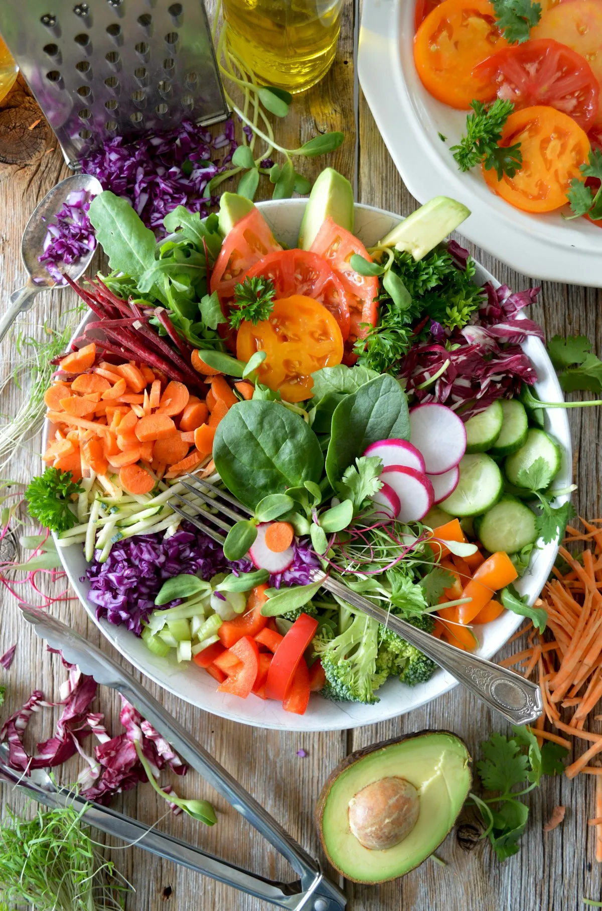 Nutrient-dense vegan nourish bowl with caramelized roasted sweet potato chunks, black beans, curly kale, and creamy garlic tahini drizzle
